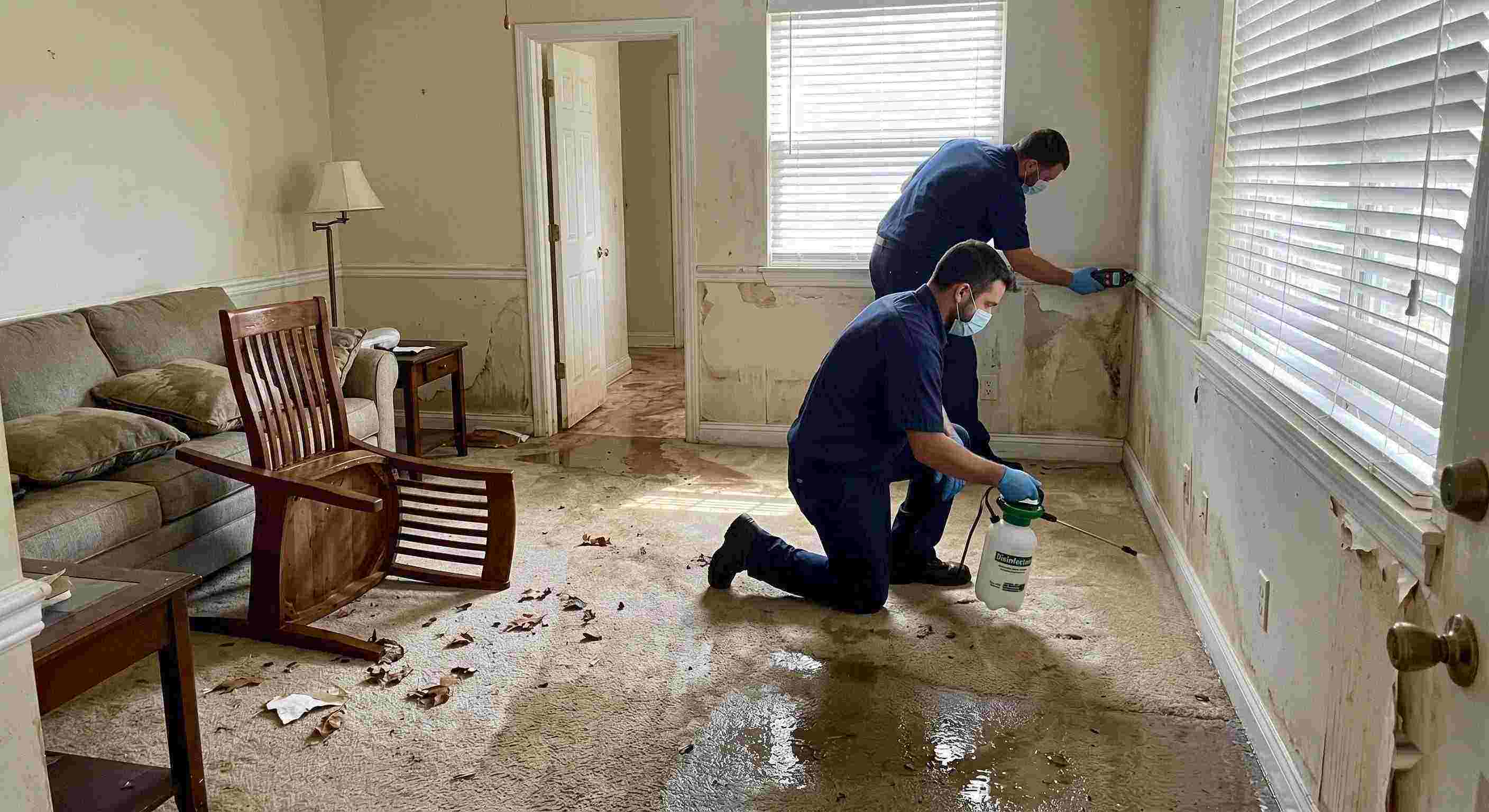 Technicians performing flood disinfection after water damage inside a home in Salt Lake City, ensuring wet floors, damp walls, and household items are sanitized safely.
